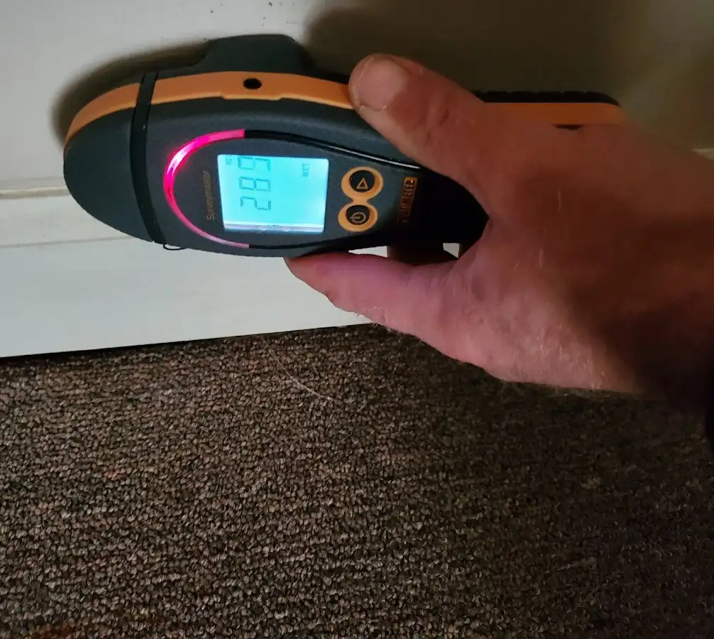 Moisture detection at baseboard during Storm Damage Restoration in Falls